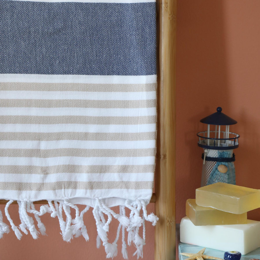 Turkish peshtemal beach towel has brown and navy stripes and tassels